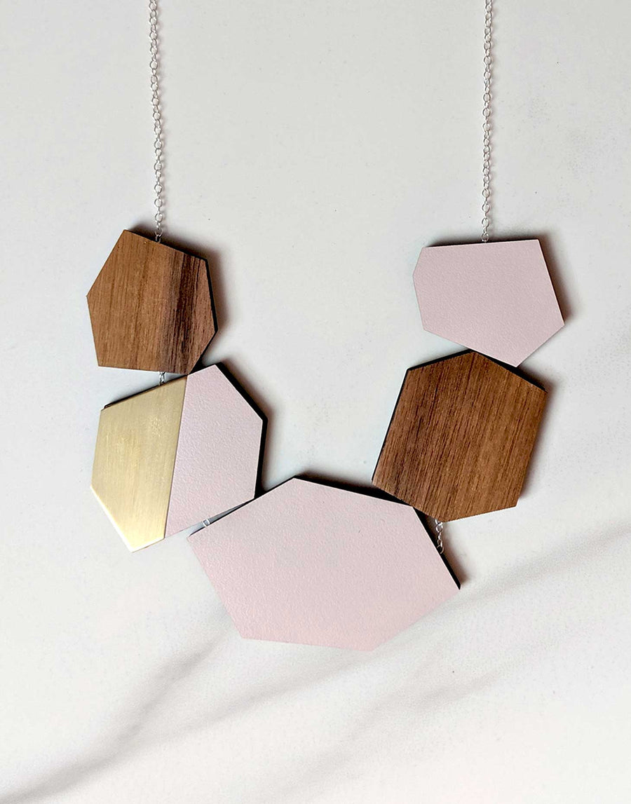 wooden statement necklace in pink and brass close up
