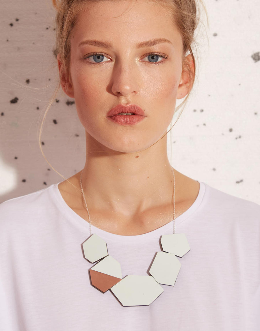 geometric statement necklace in copper and green formica on model