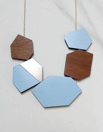 steel statement necklace with blue formica in close up